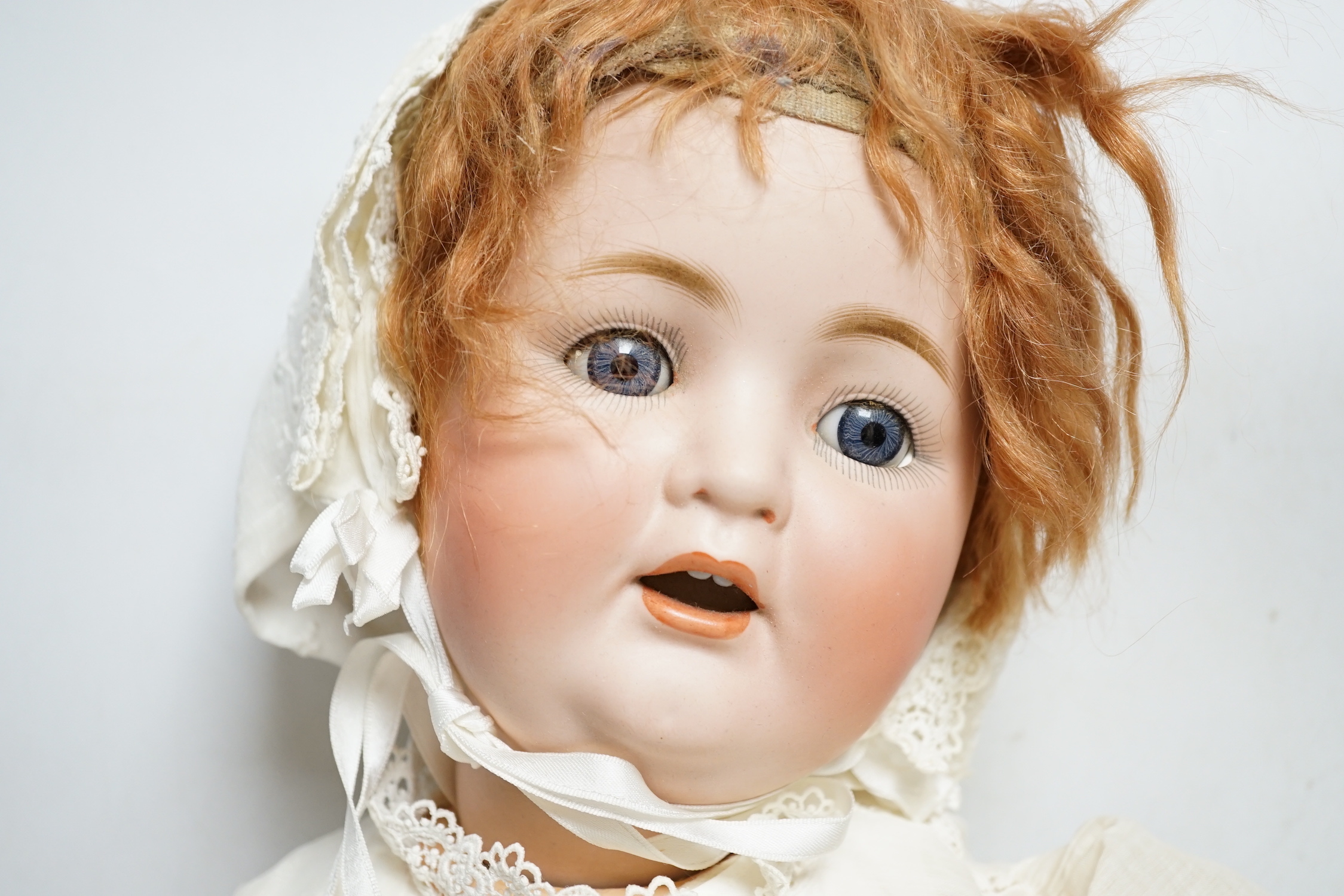 A German bent limb doll, height 63cm, hands damaged, vintage clothes, Cherie French doll's head on replaced new body, two hard plastic dolls, one Pedigree AM Dream Baby doll, soft body, small hard plastic baby in crib